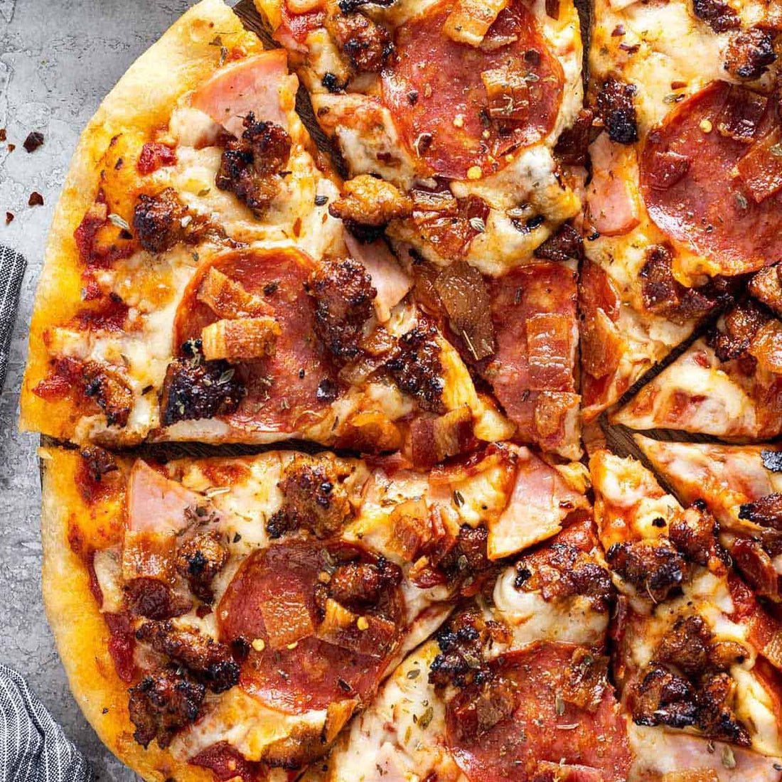 A pizza with meat toppings on it.