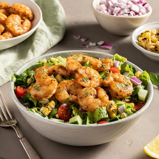 Cajun shrimp bowl surrounded by other ingredients on a table