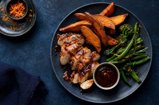 Healthy BBQ sauce served with grilled chicken, roasted potatoes, and green vegetables