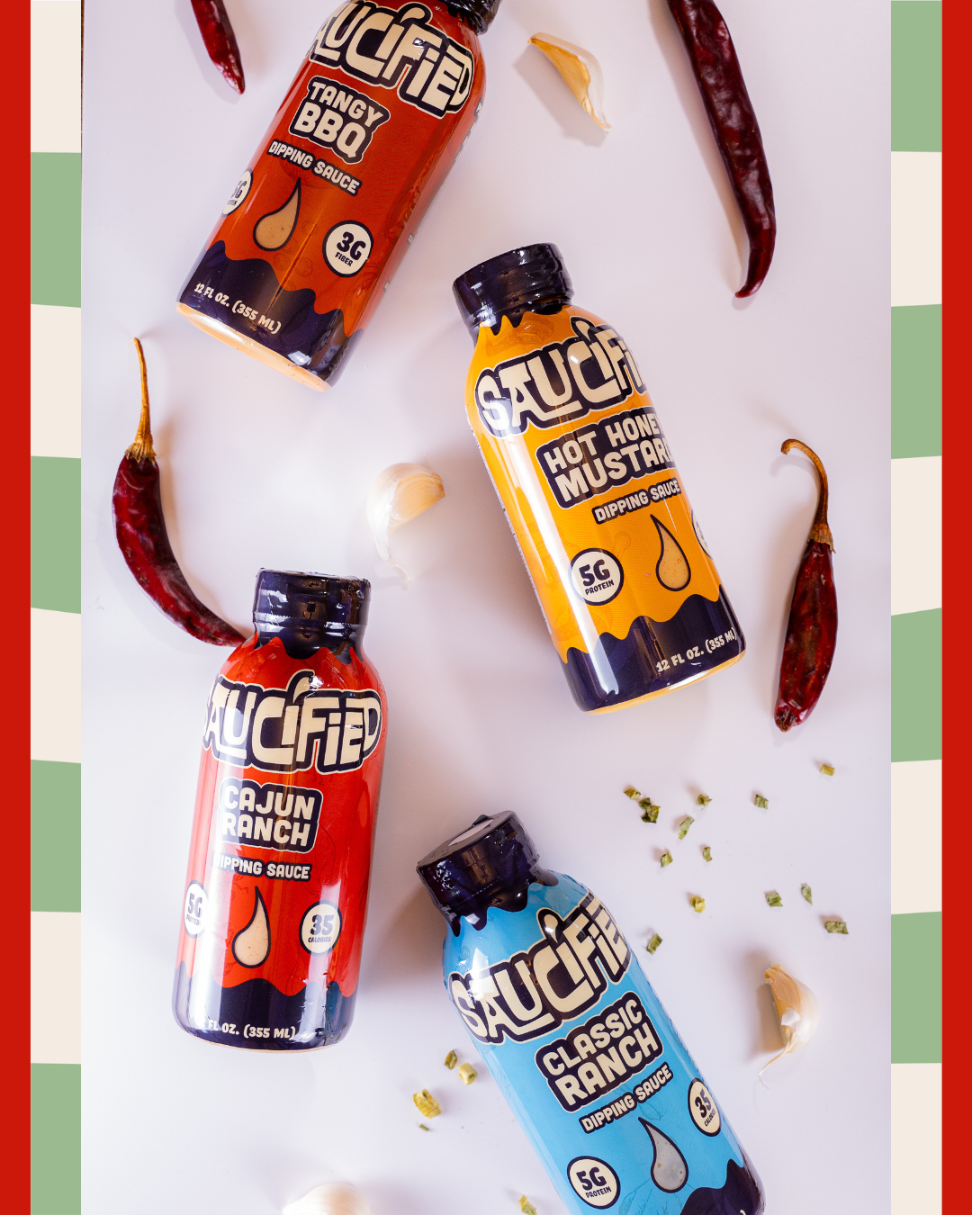 Four bottles of Saucified sauces surrounded by ingredients on a white background with red and green borders.